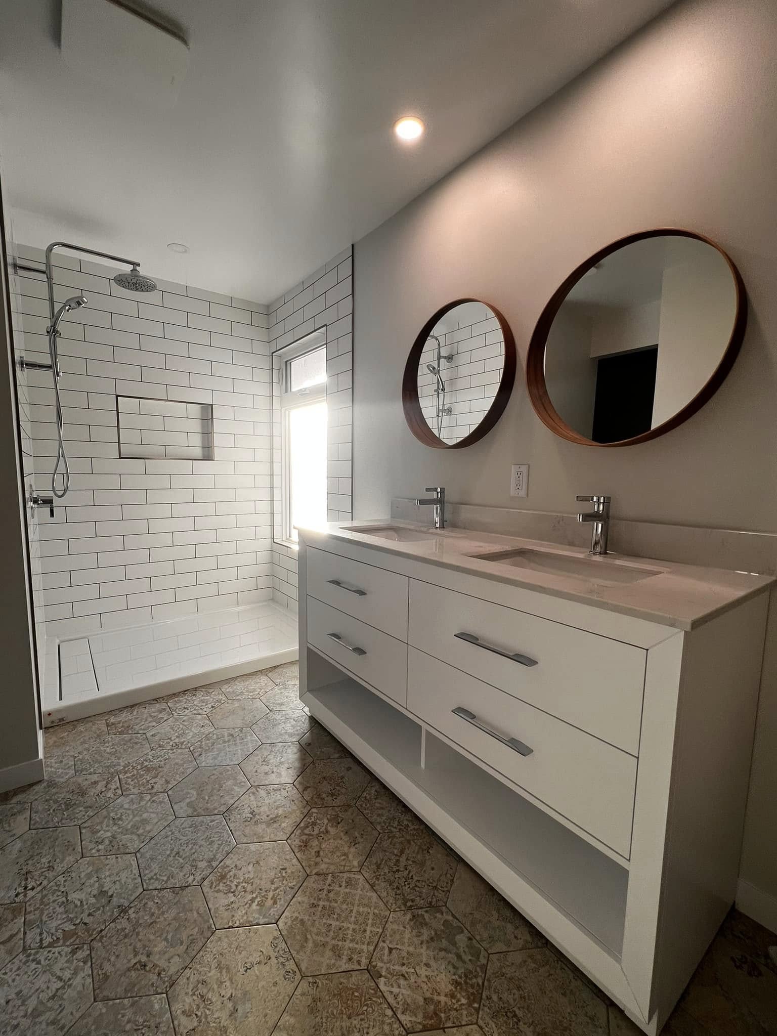 Double vanity suite with hexagon tile floor